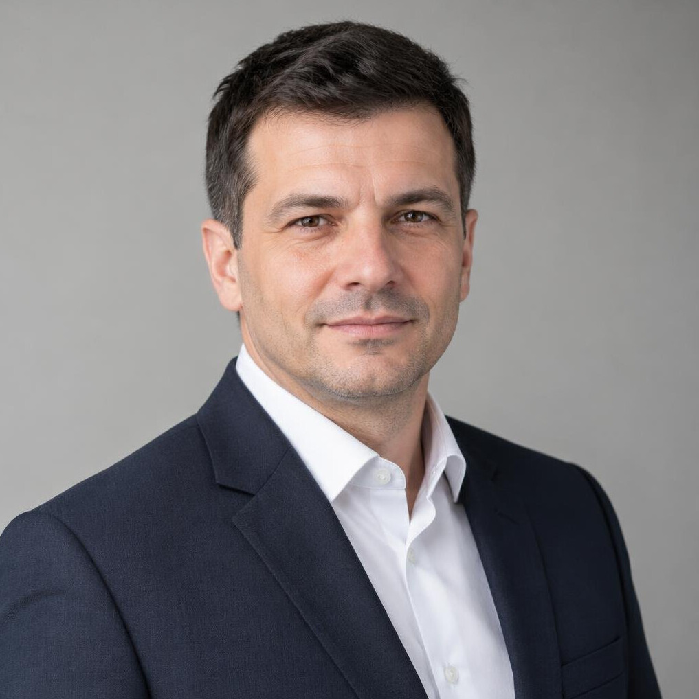 Portrait of a man in a suit with a confident expression